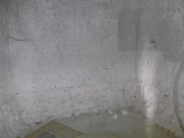 Cave house interior with rough stone walls in Benamaurel, Granada, showcasing traditional undergroun.