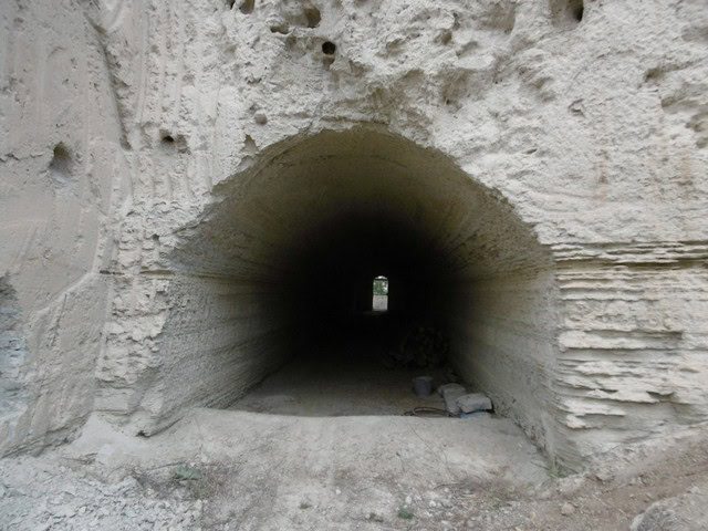 Cave house entrance in Benamaurel, Granada, with a tunnel leading to the interior.