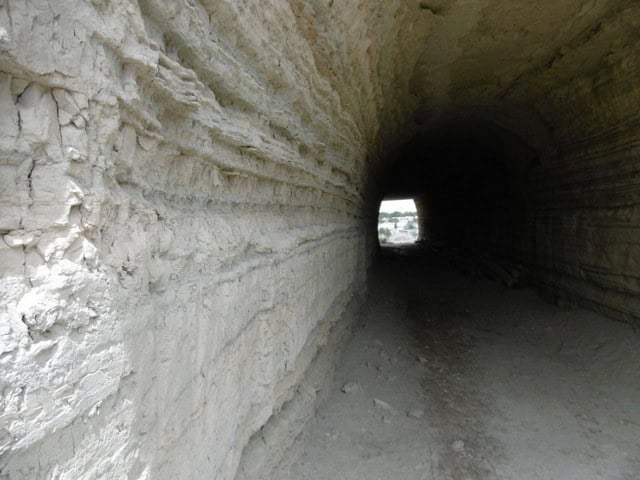 Cave House in Benamaurel, Granada with tunnel entrance and natural rock formations.