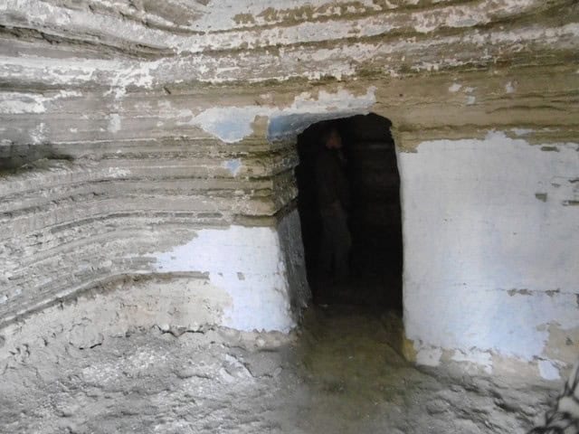 Cave house entrance in Benamaurel, Granada with natural rock walls.