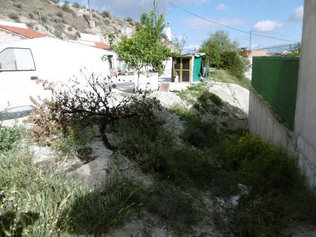 Cave house with garden in Benamaurel, Granada, Spain, surrounded by natural landscape and traditiona.