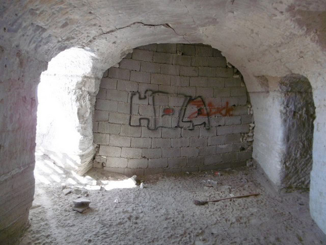 Cave house interior with stone walls and graffiti in Benamaurel, Granada. Unique property for sale i.