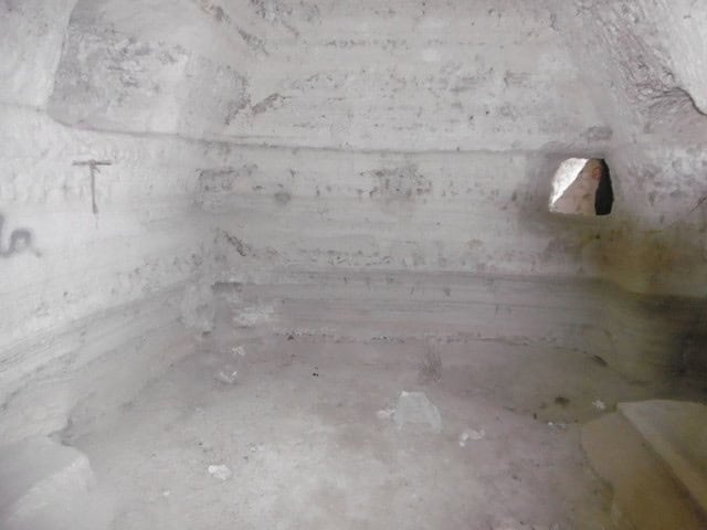 Ancient cave house interior in Benamaurel, Granada, showcasing natural rock walls and unique archite.