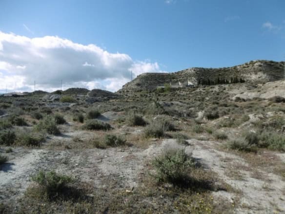 Land for sale in Benamaurel, Granada with scenic mountain views and natural landscape.