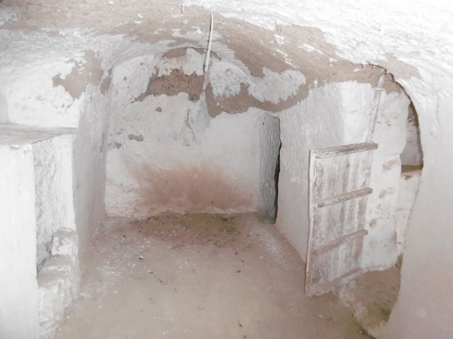 Cave house interior in Benamaurel, Granada, showcasing traditional underground living space.