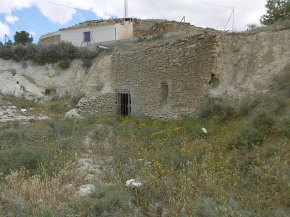Traditional cave house in Benamaurel, Granada with stone walls and rustic charm.