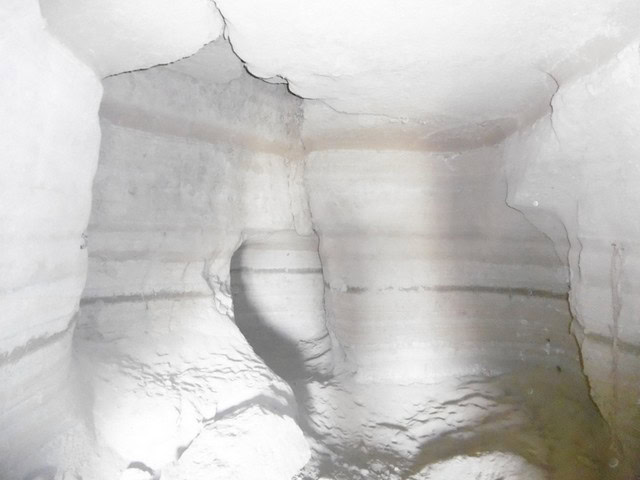 Cave house interior in Benamaurel, Granada, showcasing natural rock formations and rustic living spa.