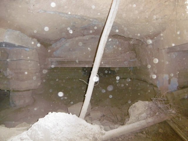 Cave house interior in Benamaurel, Granada, showing rustic stone walls and underground living space.