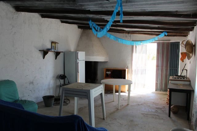 Charming rural property interior in Lucar, Almeria, with rustic ceiling beams and simple furnishings.