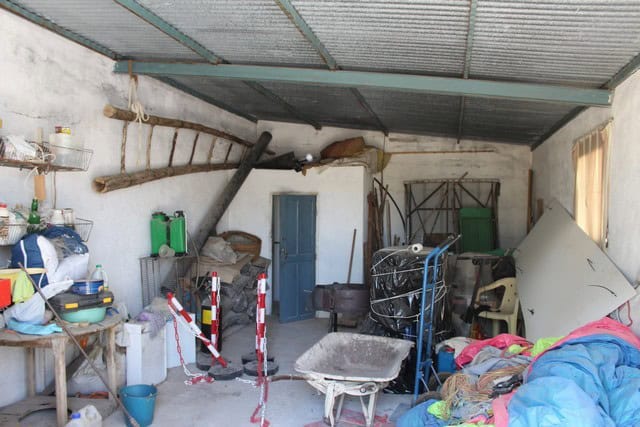 Rural property interior in Lucar, Almeria, with storage and gardening tools.