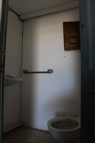 Interior of rural bathroom in Lucar, Almeria with basic fixtures and simple design.