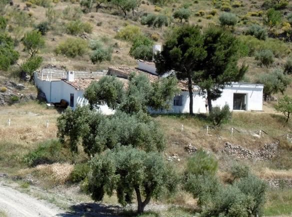 Rural property with white buildings in Sufli, Almeria, surrounded by trees and natural landscape.
