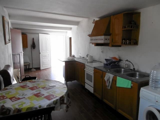Rural property kitchen in Sufli, Almeria with simple wooden cabinets and basic appliances. Ideal for.