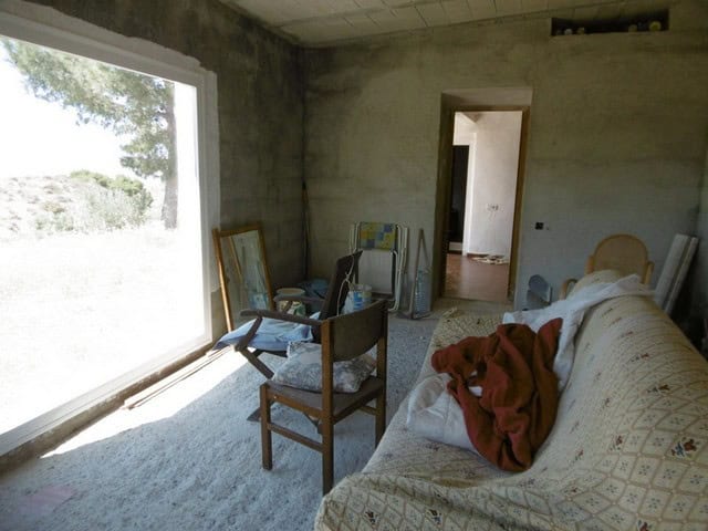 Rural property interior in Sufli, Almeria with unfinished walls and basic furnishings.