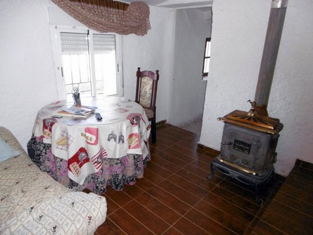 Charming interior of a rural property in Sufli, Almeria, featuring a small dining area and a traditi.