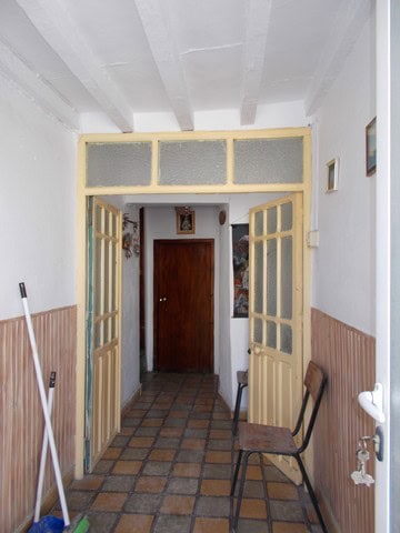 Cozy interior doorway of a town house in Seron, Almeria, featuring wooden doors and tiled flooring.