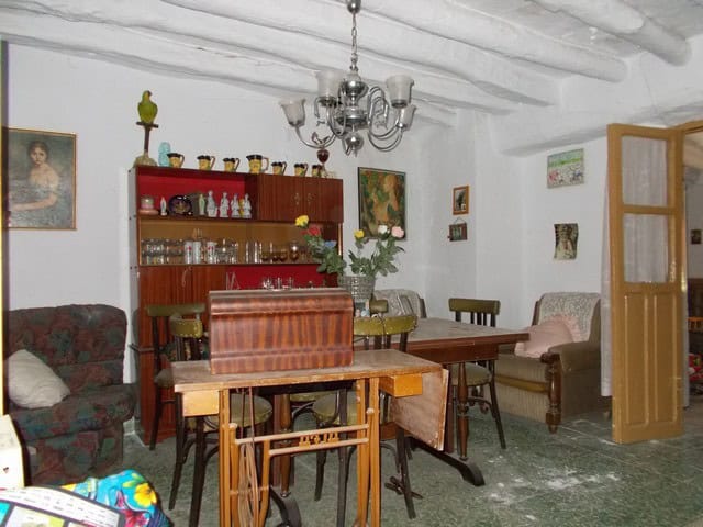 Charming interior of a town house in Seron, Almeria, featuring rustic furniture, a dining area, and.