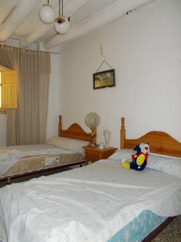 Cozy bedroom in Seron town house, Almeria with two beds and vintage decor.