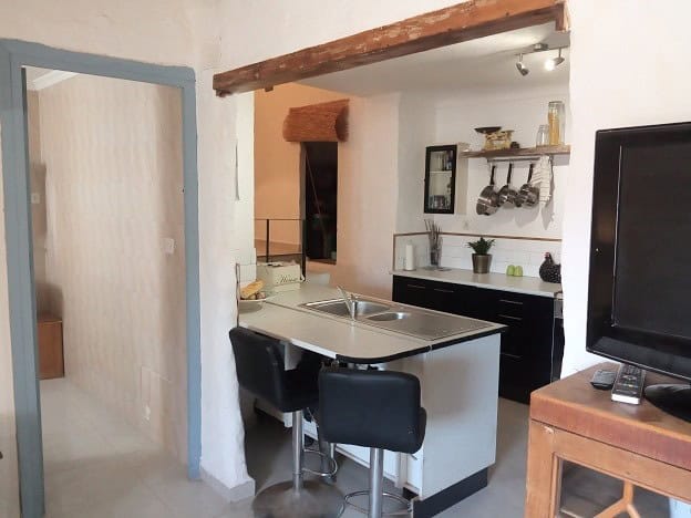 Cozy interior of a village home in Hinojares, Jaen, featuring a modern kitchen and rustic decor.