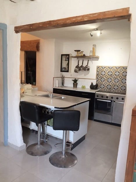 Charming village property kitchen in Hinojares, Jaen with modern appliances and rustic decor.