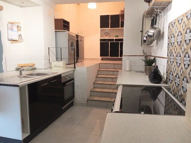 Charming village home kitchen in Hinojares, Jaen, featuring modern appliances and traditional decor.