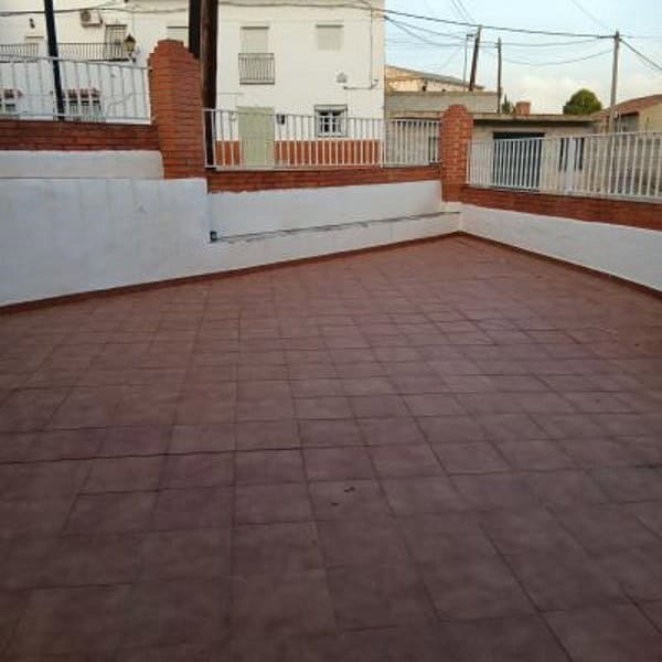 Terrace with red tiles and white walls in Villanueva de las To, Granada.