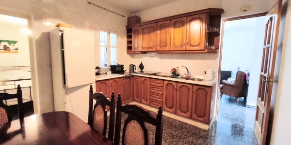 Cozy kitchen with wooden cabinets and modern appliances in Villanueva de las To.