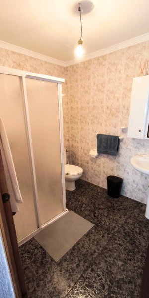Charming bathroom in a village property in Villanueva de las To, Granada, featuring a shower, toilet.