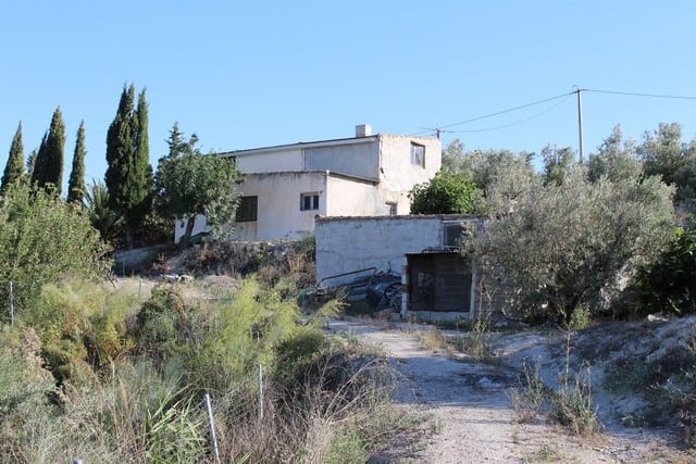 Rural property in Tijola, Almeria, featuring a traditional house surrounded by natural landscape and.