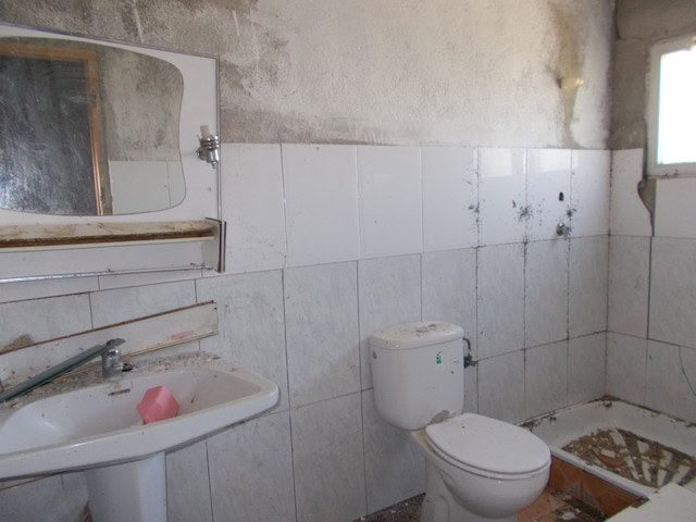 Interior of rustic rural property in Tijola, Almeria, showing unfinished bathroom with basic fixture.
