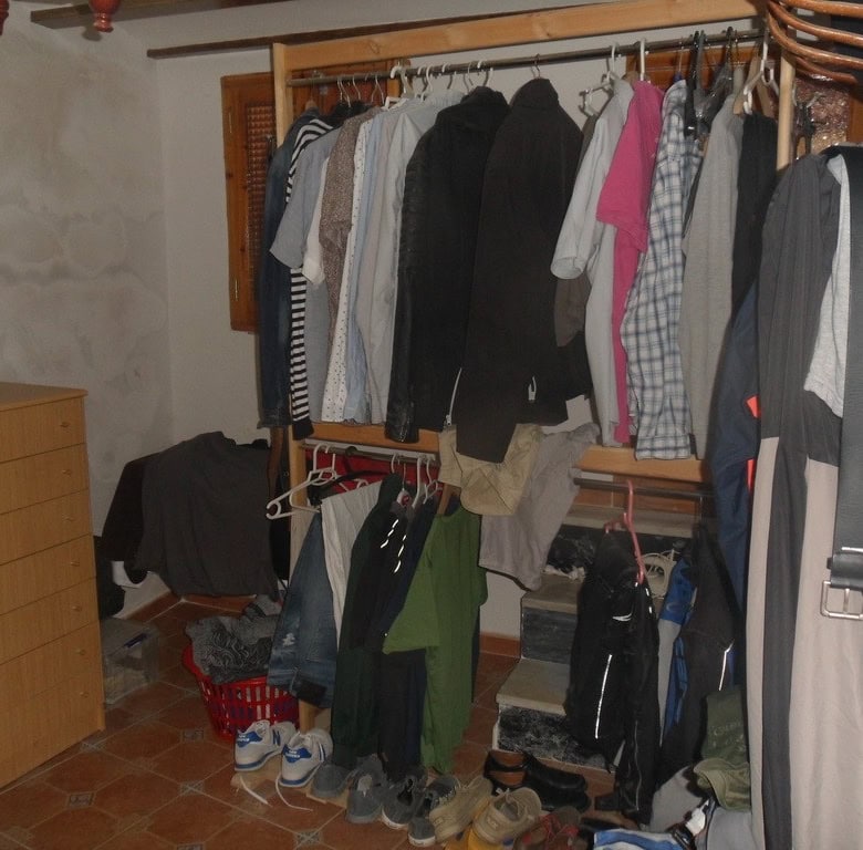 Charming village property in Cullar, Granada, featuring a cozy interior with clothing and household.