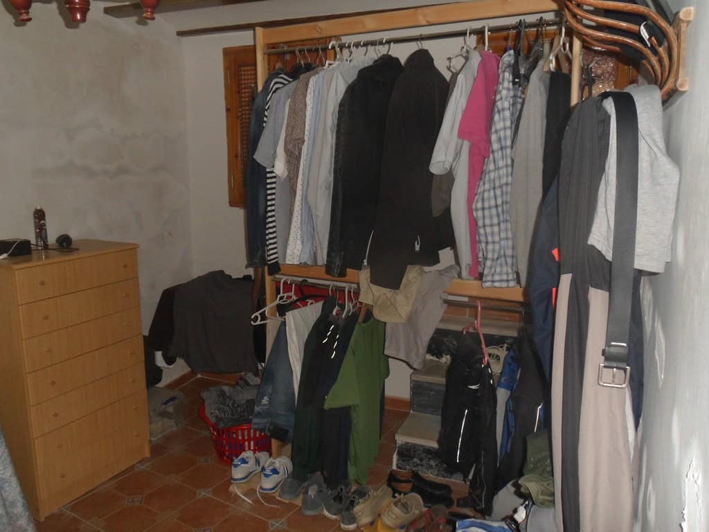 Charming village property in Cullar, Granada, featuring a cozy interior with clothing and household.