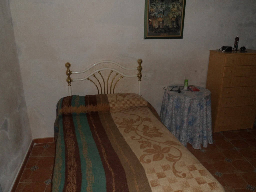 Village Property Bedroom in Cullar, Granada with simple furnishings and rustic charm.