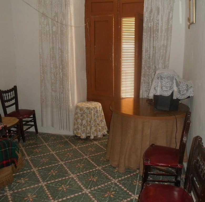 Charming interior of a village property in Cullar, Granada, featuring traditional furniture and cozy.