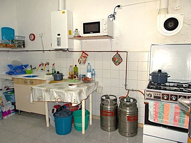 Charming kitchen in Hijate, Almeria with basic appliances, storage, and traditional decor. Perfect f.