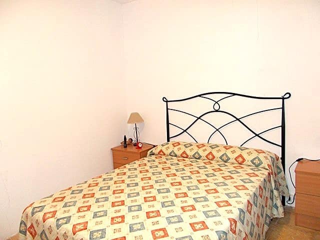 Charming village property in Hijate, Almeria, featuring a cozy bedroom with a metal bed frame and si.