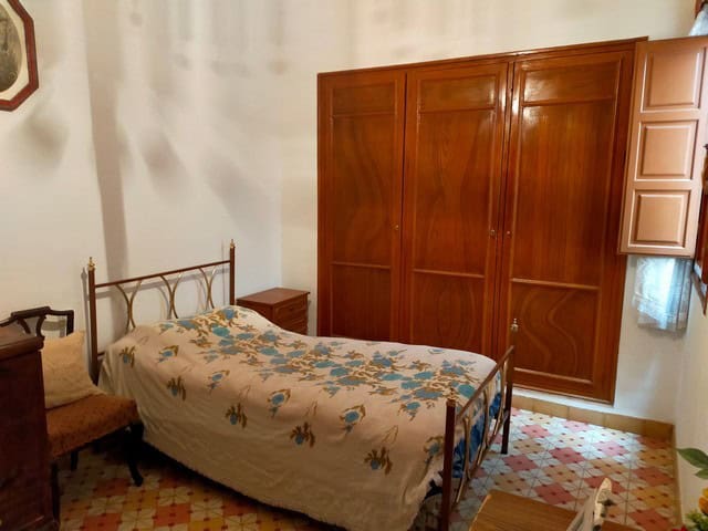 Town House in Cullar, Granada with traditional interior and wooden wardrobe.