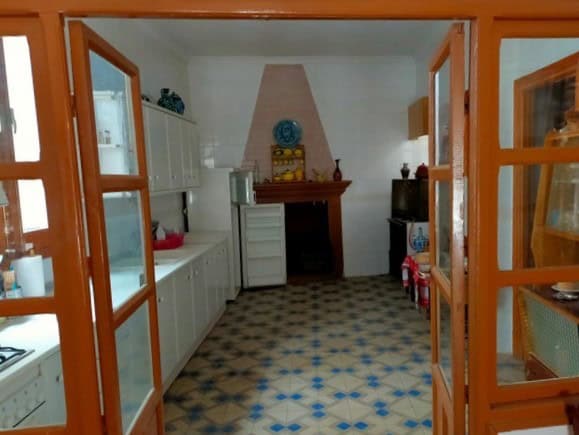 Charming kitchen of a town house in Cullar, Granada, featuring traditional decor and functional spac.