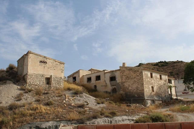 Rural property with traditional stone houses in Bayarque, Almeria, set on a hillside with scenic vie.
