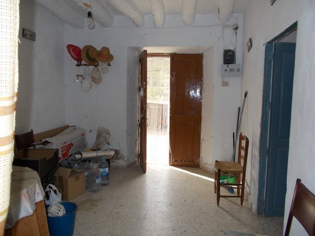 Charming rural property interior in Bayarque, Almeria, featuring simple furnishings and rustic decor.