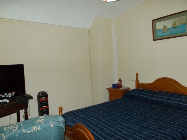 Town House in Cullar, Granada with cozy bedroom and traditional decor.