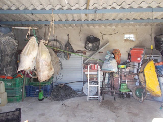 Rural property storage area in Caniles, Granada with tools and equipment.