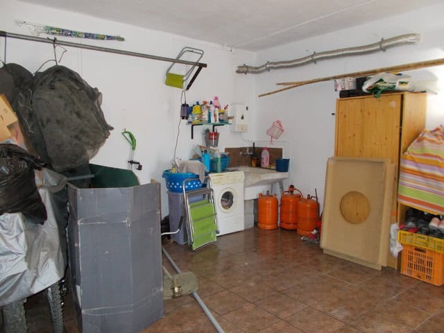 Interior of rural property with laundry area and storage in Caniles, Granada.