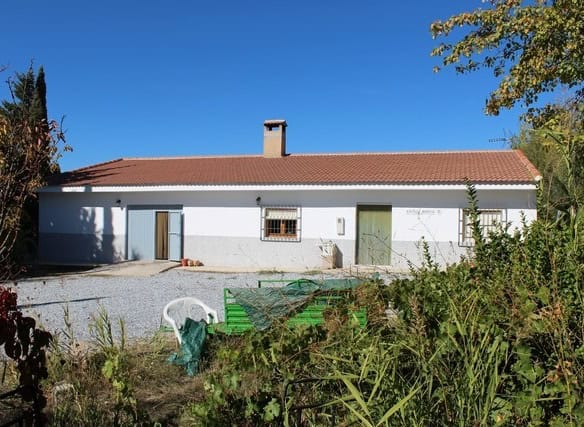 Rural property for sale in Caniles, Granada, featuring a traditional single-story house with a spaci.