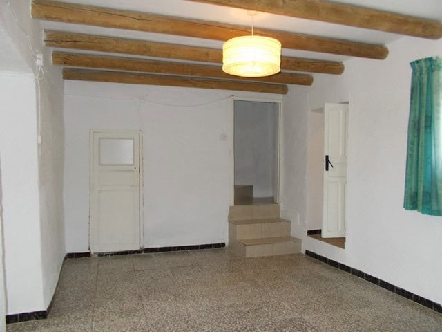Charming village property interior with rustic wooden beams and simple decor in Cela, Almeria.