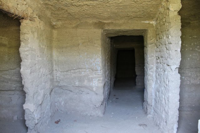 Cave house entrance in Caniles, Granada, with natural rock walls and rustic charm.