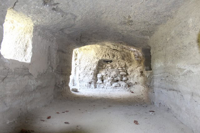 Cave house interior in Caniles, Granada, showcasing natural rock walls and unique underground living.