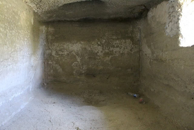 Cave house interior in Caniles, Granada, showcasing rustic stone walls and natural cave features.