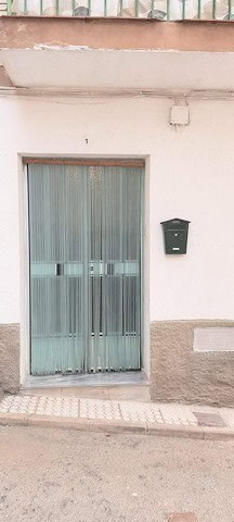Apartment entrance with glass door and mailbox in Zujar, Granada.
