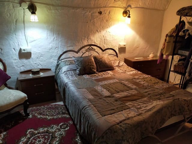 Charming cave house bedroom with rustic decor in Benamaurel, Granada. Perfect retreat for a unique A.